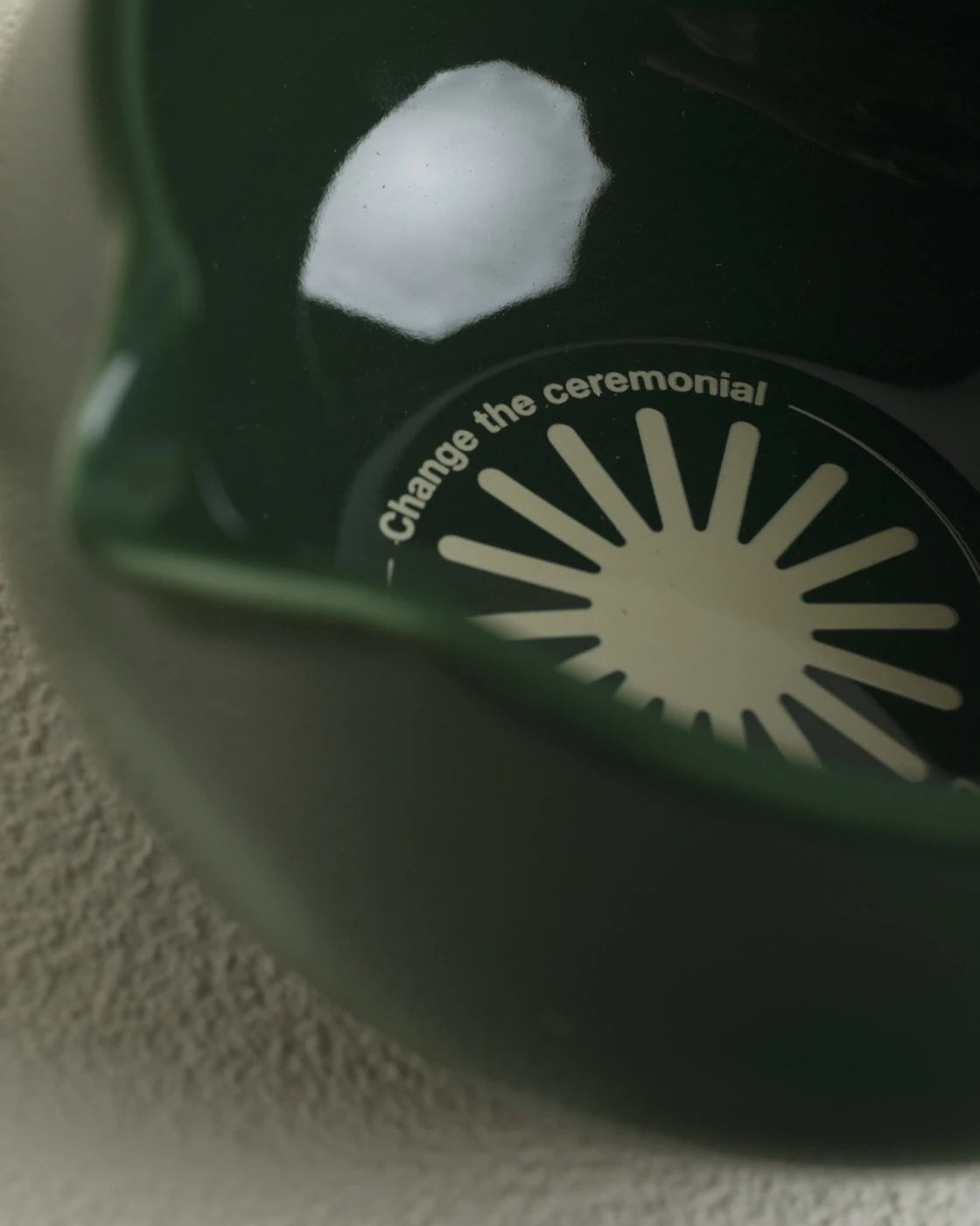 Close-up of a green object with text on a textured surface
